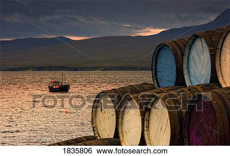 Stock Photograph - Islay, Inner Hebrides, Scotland; Barrels Stacked By Seascape. Fotosearch