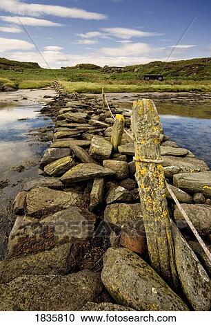 Stock Image - Isle Of Gigha, Scotland; Rocky Shoreline And Wharf. Fotosearch