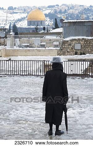 Israel, Galicia courtyard; Jerusalem, 2013, Orthodox Jew standing in melting snow on January 10 View Large Photo Image Stock Image - Israel, Galicia courtyard; Jerusalem, 2013, Orthodox Jew standing in melting snow on January 10. Fotosearch