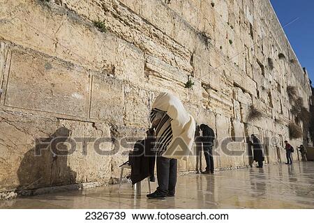 Stock Photo - Israel, Jerusalem, Jew with prayer shawl praying at Western Wall; Jerusalem Old City. Fotosearch