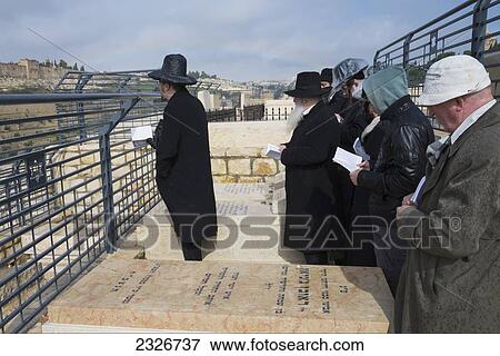 Stock Photo - Israel, Jerusalem, Jews praying on tomb at Mount of Olives; Jerusalem Old City. Fotosearch