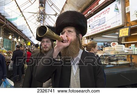 Israel, Jerusalem, Orthodox Jew blowing little horn to announce start of Shabat in Mahane Yehuda market; Jerusalem Old City View Large Photo Image Stock Image - Israel, Jerusalem, Orthodox Jew blowing little horn to announce start of Shabat in Mahane Yehuda market; Jerusalem Old City. Fotosearch