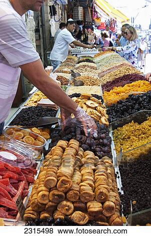 Israel, Jerusalem, Two market vendors selling dried fruit and nuts to customers View Large Photo Image Stock Photo - Israel, Jerusalem, Two market vendors selling dried fruit and nuts to customers. Fotosearch