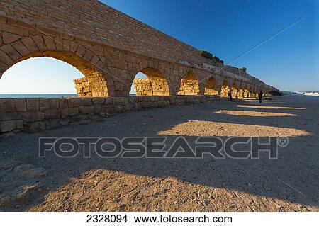 Picture - Israel, near town of Caesarea. Ancient Caesarea Maritima city and harbor was built by Herod Great. city has been populated through late Roman and Byzantine era; Caesarea Maritima National Park, Caesarea Maritima is a national park on Israeli coastline. Fotosearch