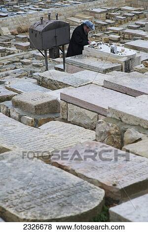 Israel, Orthodox Jew praying at tomb at Mount of Olives cemetery; Jerusalem View Large Photo Image Stock Photo - Israel, Orthodox Jew praying at tomb at Mount of Olives cemetery; Jerusalem. Fotosearch