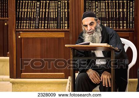 Stock Photo - Israel, Orthodox Jew reading Torah; Jerusalem. Fotosearch