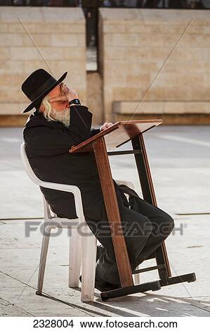 Picture - Israel, Side view of man with Wailing wall in background; Jerusalem. Fotosearch