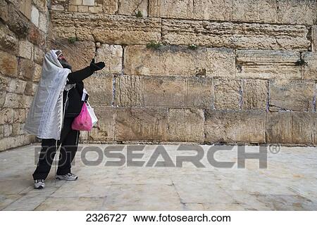 Stock Photo - Israel, Western Wall; Jerusalem, 2013, January 10, Orthodox Jew standing in front of wall. Fotosearch