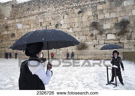 Stock Photograph - Israel, Western Wall; Jerusalem, 2013, January 10, Tourist photographing friend. Fotosearch