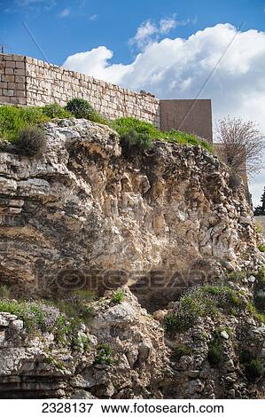 Israel, where Jesus was crucified. You can see in rock formation what looks to be a skull; Jerusalem, place of skull, Calvary, View from Garden Tomb area where Jesus was buried towards Golgotha View Large Photo Image Stock Photo - Israel, where Jesus was crucified. You can see in rock formation what looks to be a skull; Jerusalem, place of skull, Calvary, View from Garden Tomb area where Jesus was buried towards Golgotha. Fotosearch