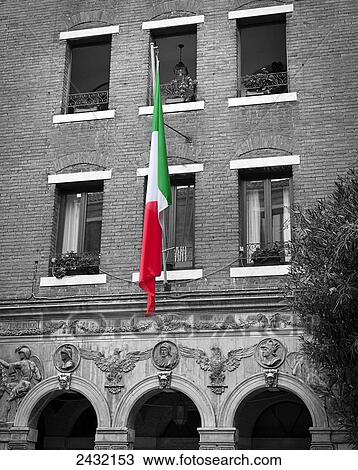 Stock Image - Italian flag in colour against a grey brick building; Venice, Italy. Fotosearch