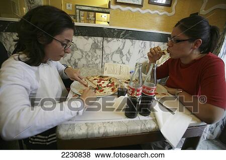 Stock Photo - Italy, Customers Eating Pizza At Pizzeria Trianon Da Ciro; Naples. Fotosearch