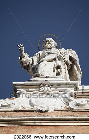 Stock Photograph - Italy, Emilia-Romagna, Bologna, Low angle view of stone statue with blue sky. Fotosearch