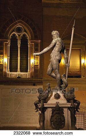 Stock Photo - Italy, Emilia-Romagna, Bologna, Neptune fountain and Palazzo Re Enzo walls at night. Fotosearch