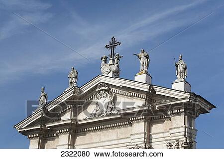 Italy, Emilia-Romagna, Ferrara, Church decoration with statues and cross against blue sky View Large Photo Image Stock Image - Italy, Emilia-Romagna, Ferrara, Church decoration with statues and cross against blue sky. Fotosearch