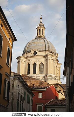 Stock Photo - Italy, Emilia-Romagna, Ferrara, Domed church tower with clouded sky. Fotosearch
