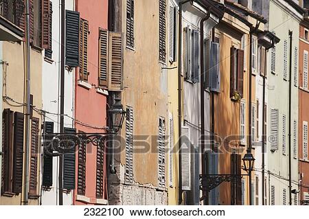 Italy, Emilia-Romagna, Parma, Close up of house facades with shutters and street lamps View Large Photo Image Stock Image - Italy, Emilia-Romagna, Parma, Close up of house facades with shutters and street lamps. Fotosearch