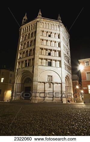 Stock Image - Italy, Emilia-Romagna, Parma, Low angle view of marble octagonal baptistery at night. Fotosearch