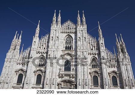 Stock Image - Italy, Lombardia, Milano, Marble facade of cathedral with blue sky. Fotosearch