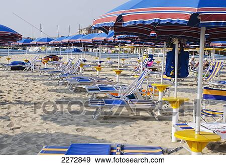 Italy, Marche, Beach umbrellas and deck chairs on sandy beach in early morning; Porto San Giorgio View Large Photo Image Stock Photo - Italy, Marche, Beach umbrellas and deck chairs on sandy beach in early morning; Porto San Giorgio. Fotosearch