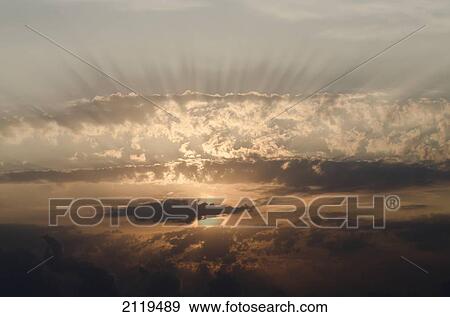 Stock Photo - Italy, Marche, Sun rays through clouds at sunrise; Porto San Giorgio. Fotosearch