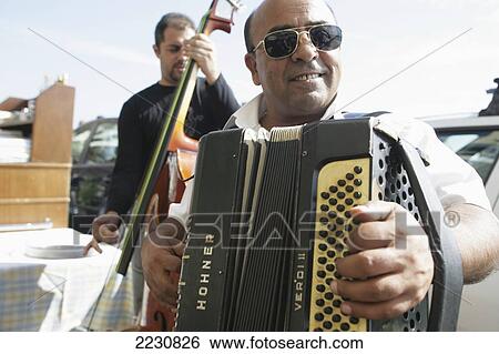 Stock Photograph - Italy, Musicians Playing Outside Restaurant On Waterfront; Naples. Fotosearch