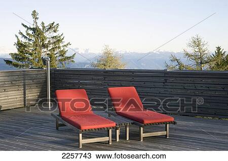 Stock Image - Italy, South Tyrol, Sun Loungers With Mountains In Background At Vigilius Mountain Resort; Lana. Fotosearch