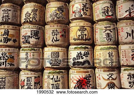 Stock Image - Japan, Beautifully Stacked Sake Containers With Colorful Japanese Writing. Fotosearch