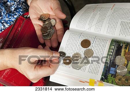 Picture - Japan, Counting Japanese Coins On Top Of Open Book; Kyoto. Fotosearch