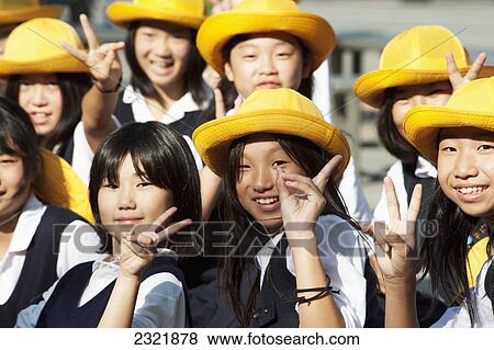 Japan, Kyoto, Group of school girls in their uniforms and yellow hats giving peace symbol View Large Photo Image Stock Photo - Japan, Kyoto, Group of school girls in their uniforms and yellow hats giving peace symbol. Fotosearch
