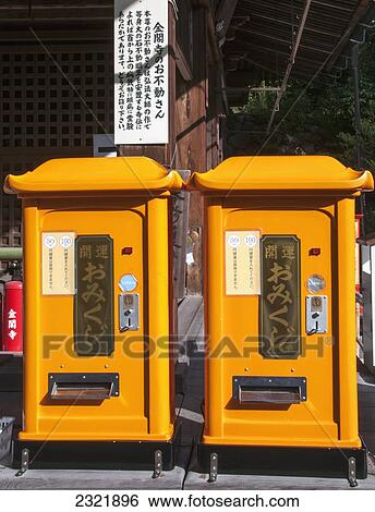 Stock Photograph - Japan, Kyoto, Two bright yellow vending machines side by side at Teapot Lane. Fotosearch
