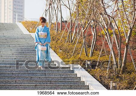 Picture - Japan, Tokyo, Pretty Japanese Woman In A Blue Kimono Walking On Stairs.. Fotosearch