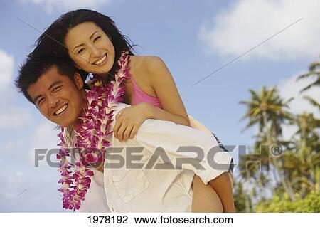 Japanese Couple On The Beach Wearing Leis. View Large Photo Image Stock Image - Japanese Couple On The Beach Wearing Leis.. Fotosearch