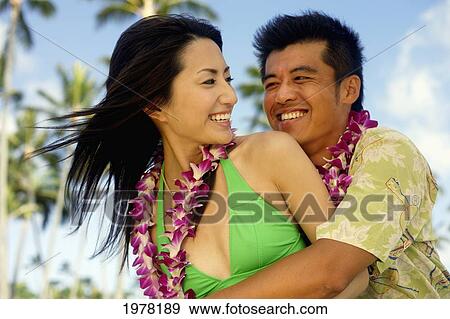 Japanese Couple On The Beach Wearing Leis. View Large Photo Image Stock Photo - Japanese Couple On The Beach Wearing Leis.. Fotosearch