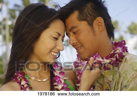 Japanese Couple On The Beach Wearing Leis. View Large Photo Image Stock Photograph - Japanese Couple On The Beach Wearing Leis.. Fotosearch