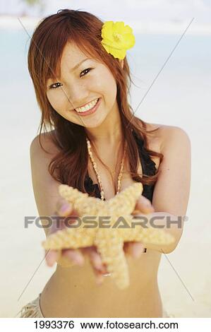 Japanese Girl In Hula Skirt Holding Out A Starfish View Large Photo Image Stock Photograph - Japanese Girl In Hula Skirt Holding Out A Starfish. Fotosearch