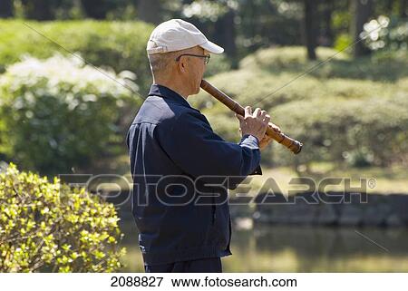 Japanese Man Playing Traditional Flute In A Park; Tokyo, Japan View Large Photo Image Stock Photo - Japanese Man Playing Traditional Flute In A Park; Tokyo, Japan. Fotosearch