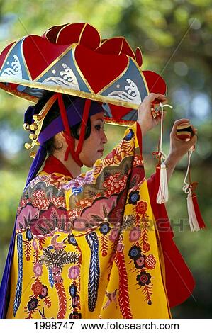 Stock Photo - Japanese Woman In Ornamental Kimono, Hat, Colorful Okinawan Festival. Fotosearch