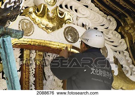 Japanese Worker Applying Gold Leaf To Restore Temple Arch; Nikko Tochigi Japan View Large Photo Image Stock Photograph - Japanese Worker Applying Gold Leaf To Restore Temple Arch; Nikko Tochigi Japan. Fotosearch