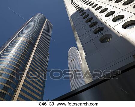 Stock Photo - Jardine House With Two International Finance Center In Background; Hong Kong, China. Fotosearch
