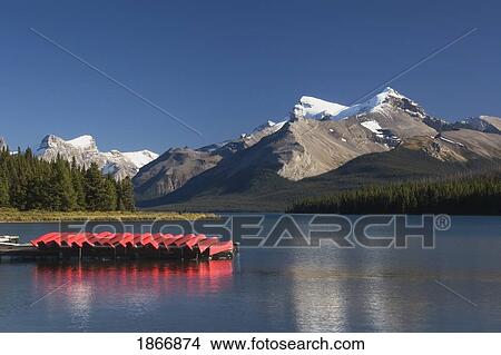Jasper National Park, Alberta, Canada; Canoes And A Dock And Mountains In Maligne Lake View Large Photo Image Picture - Jasper National Park, Alberta, Canada; Canoes And A Dock And Mountains In Maligne Lake. Fotosearch
