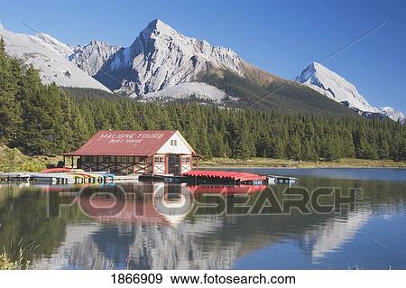 Stock Photo - Jasper National Park, Alberta, Canada; Canoes On A Dock On Maligne Lake With Mountains In The Background. Fotosearch