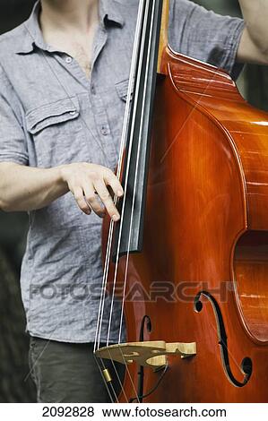 Stock Photo - Jazz Musician Playing Bass; Winnipeg Manitoba Canada. Fotosearch