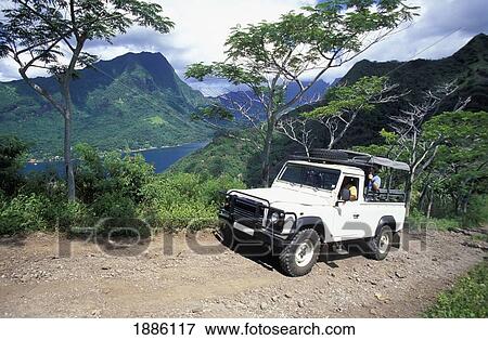 Stock Photo - Jeep Climbing Dirt Road By Lush Coastline. Fotosearch