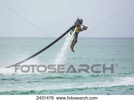 Jet pack over the Caribbean; Grand Cayman, Cayman Islands View Large Photo Image Stock Photo - Jet pack over the Caribbean; Grand Cayman, Cayman Islands. Fotosearch