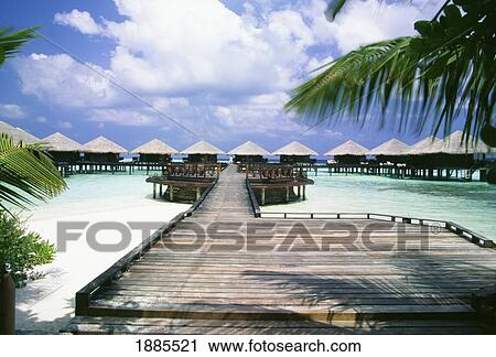 Stock Image - Jetty And Walkway To Huts On Stilts. Fotosearch