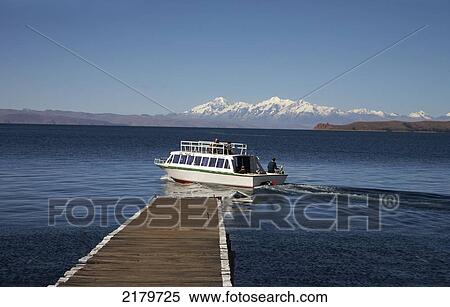 Stock Photography - Jetty with ferry leaving from the Island of The Sun, Lake Titicaca; Bolivia. Fotosearch