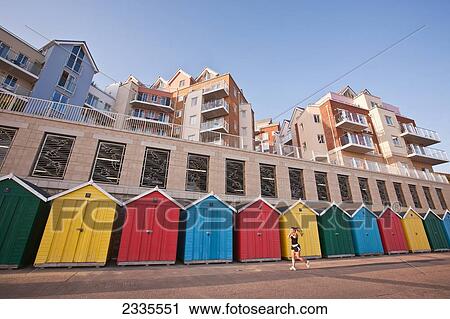 Jogger And Colorful Beach Huts And Apartments At Honeycombe Beach Development Next To Boscombe Pier; Bournemouth, Dorset, England, Uk View Large Photo Image Stock Image - Jogger And Colorful Beach Huts And Apartments At Honeycombe Beach Development Next To Boscombe Pier; Bournemouth, Dorset, England, Uk. Fotosearch