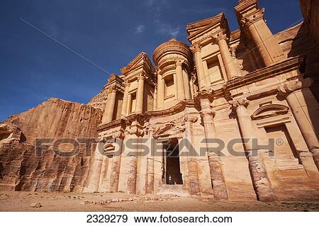 Jordan, it measures 50 metres wide by approximately 45 metres high; Petra, Ad Deir (Arabic for The Monastery) is monumental building carved out of rock in ancient city of Petra. Built by Nabataeans in 1st century View Large Photo Image Stock Photo - Jordan, it measures 50 metres wide by approximately 45 metres high; Petra, Ad Deir (Arabic for The Monastery) is monumental building carved out of rock in ancient city of Petra. Built by Nabataeans in 1st century. Fotosearch