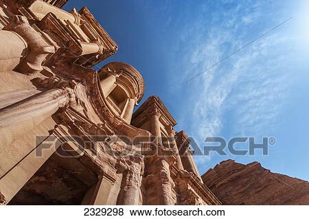 Stock Photo - Jordan, it measures 50 metres wide by approximately 45 metres high; Petra, Low angle view of Ad Deir (Arabic for The Monastery) is monumental building carved out of rock in ancient city of Petra. Built by Nabataeans in 1st century. Fotosearch